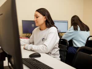 RN students using computers for work and testing